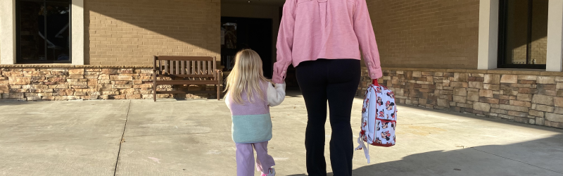 Mom and daughter walk to school